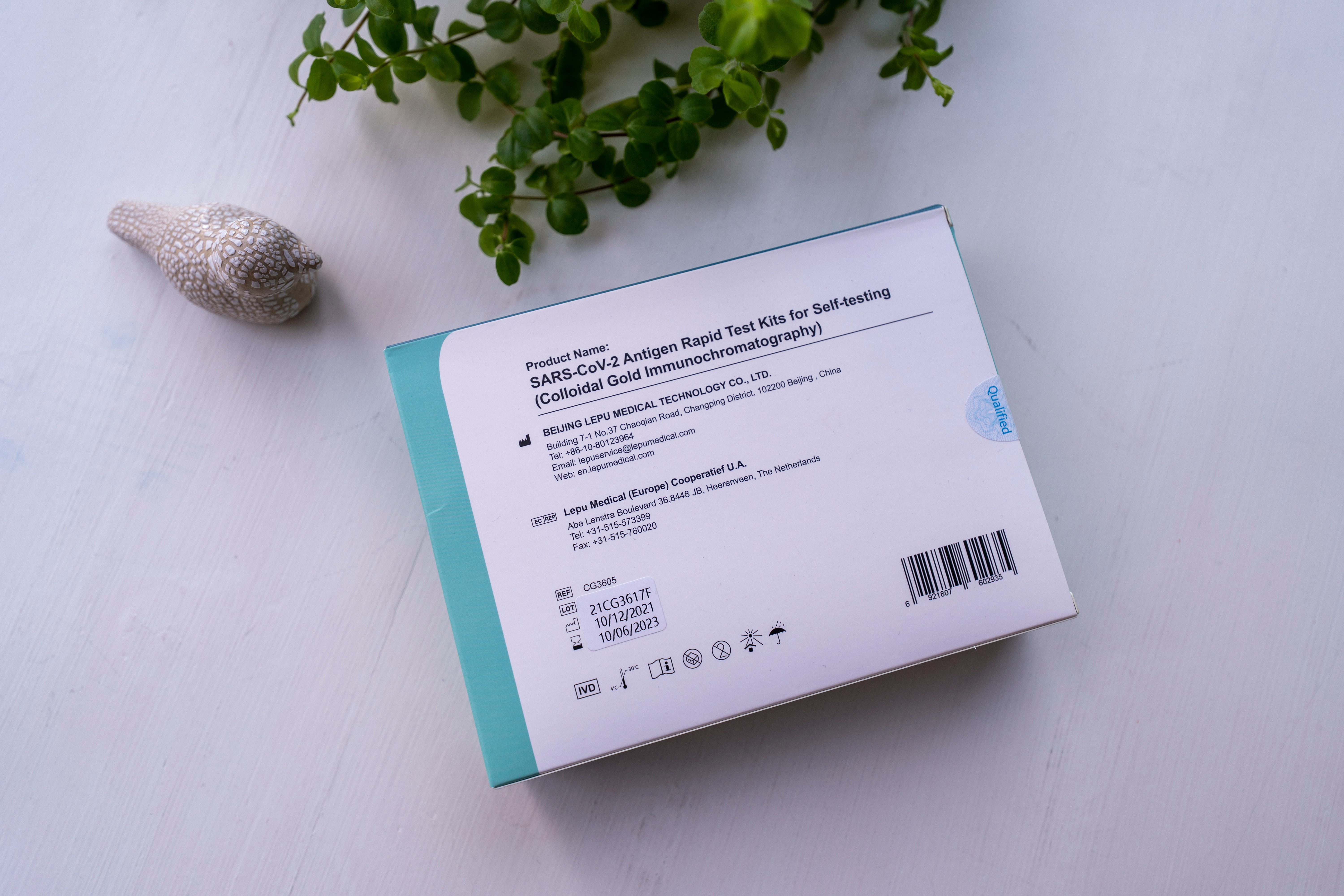 Product packaging with barcode and ingredients text on a white tabletop